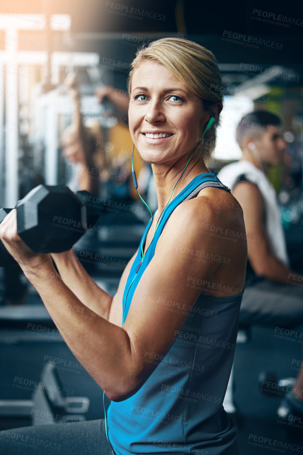 Buy stock photo Shot of a woman doing weight exercises at the gym