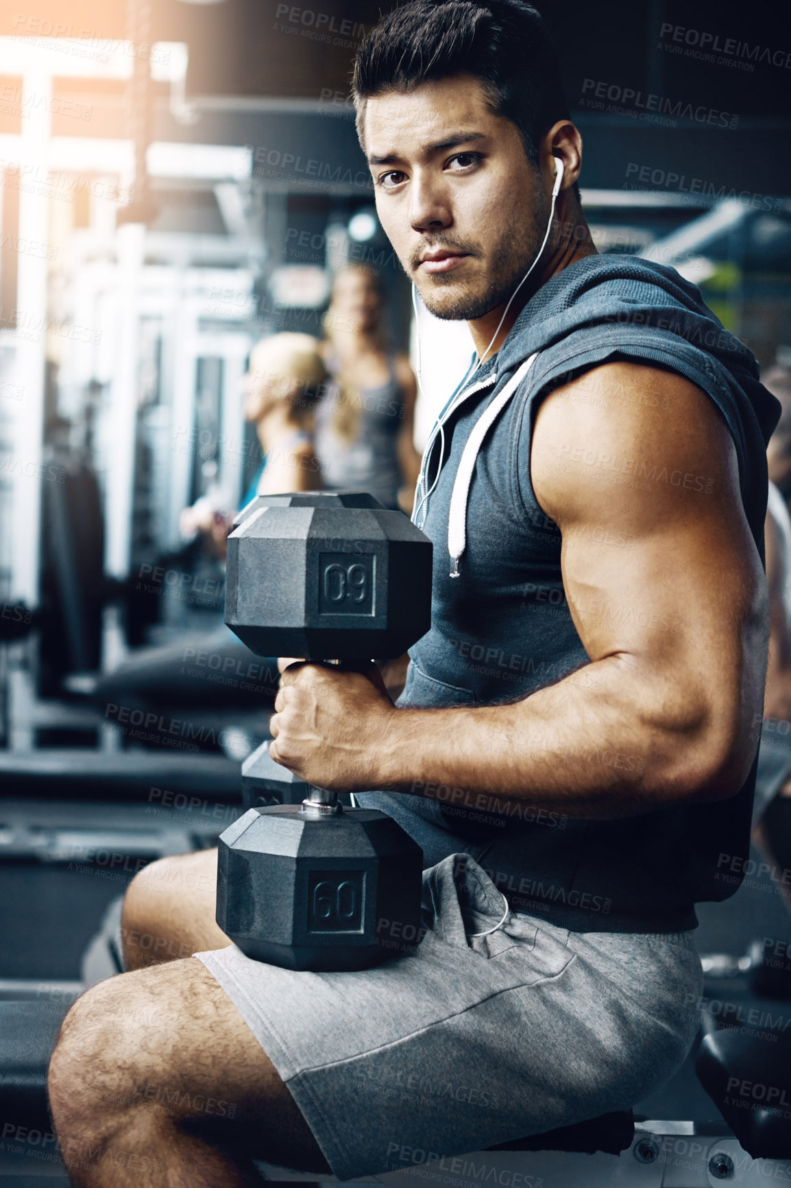 Buy stock photo Shot of a man doing a upper-body workout at the gym