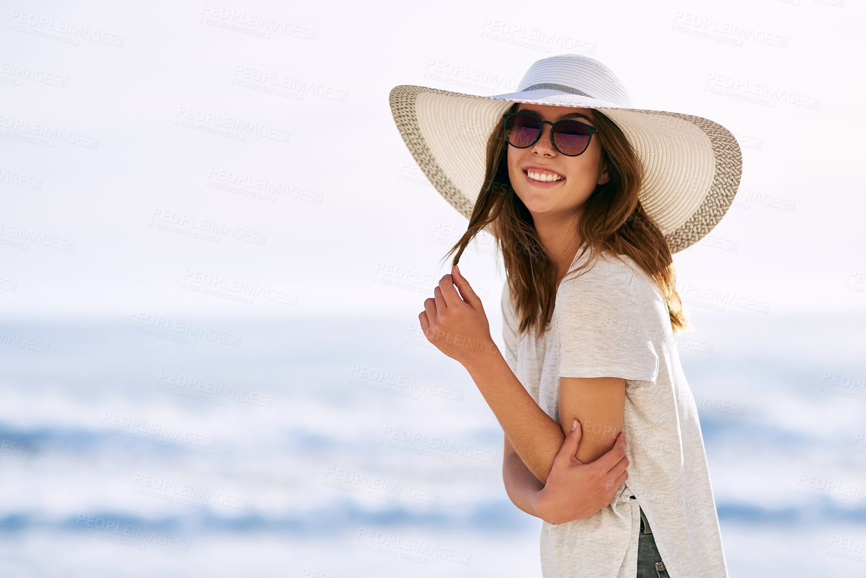 Buy stock photo Cropped shot of a beautiful young woman posing on the beach