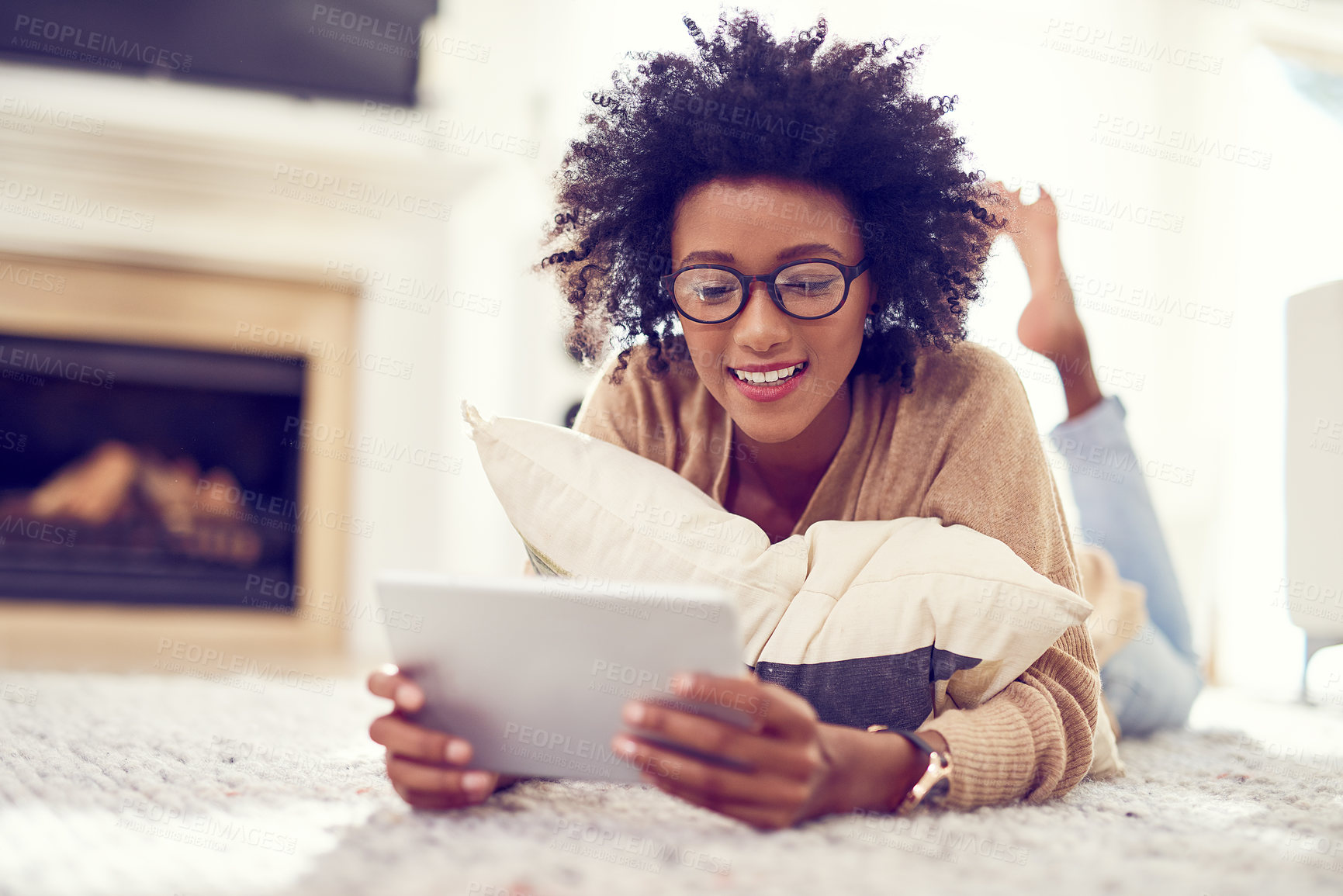 Buy stock photo Shot of a young woman using a digital tablet at home