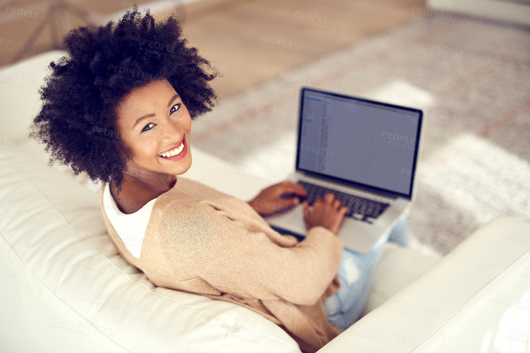 Buy stock photo Shot of a young woman using a laptop at home