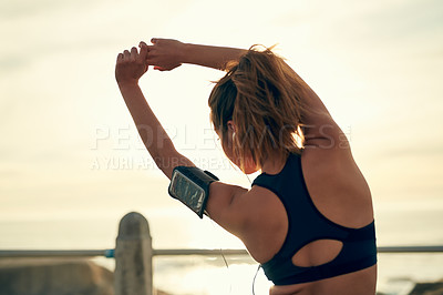 Buy stock photo Girl, runner and stretching arms at beach, outdoor and warm up for exercise or fitness training. Female person, back and athlete for cardio preparation, muscle flexibility and music for workout