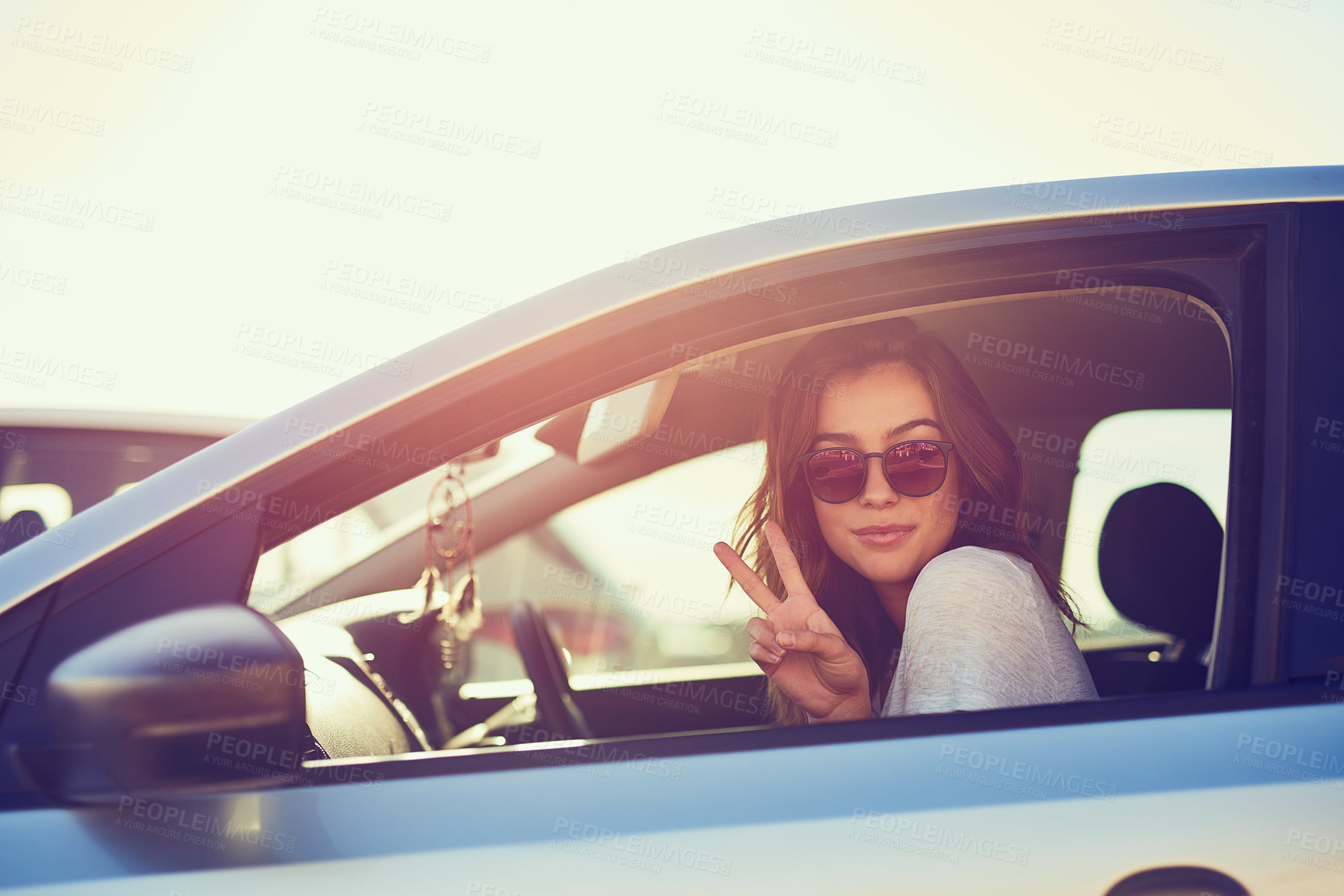 Buy stock photo Woman, car and sunglasses by window in summer for travel, freedom and vacation with sunshine outdoor. Girl, shades and relax with peace sign in motor for road trip, holiday or adventure in California