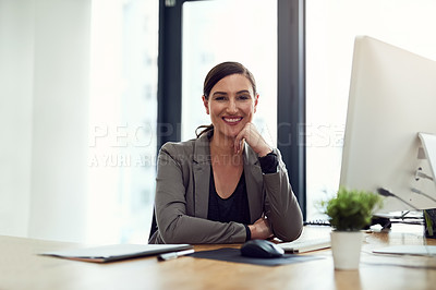 Buy stock photo Portrait of a young businesswoman sitting at her desk in an office