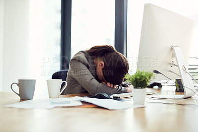 Buy stock photo Cropped shot of an exhausted young businesswoman lying with her head on her desk