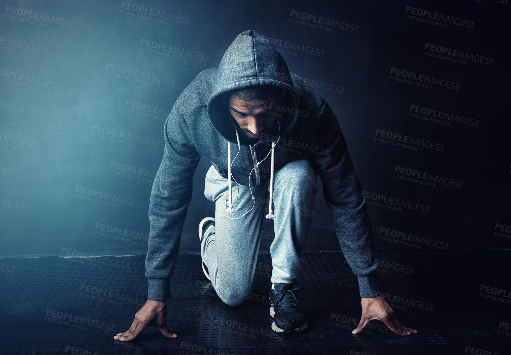 Buy stock photo Running, start and man in studio with challenge, health and wellness in hoodie at gym workout. Fitness, ready and confident runner with marathon training, commitment and exercise on dark background