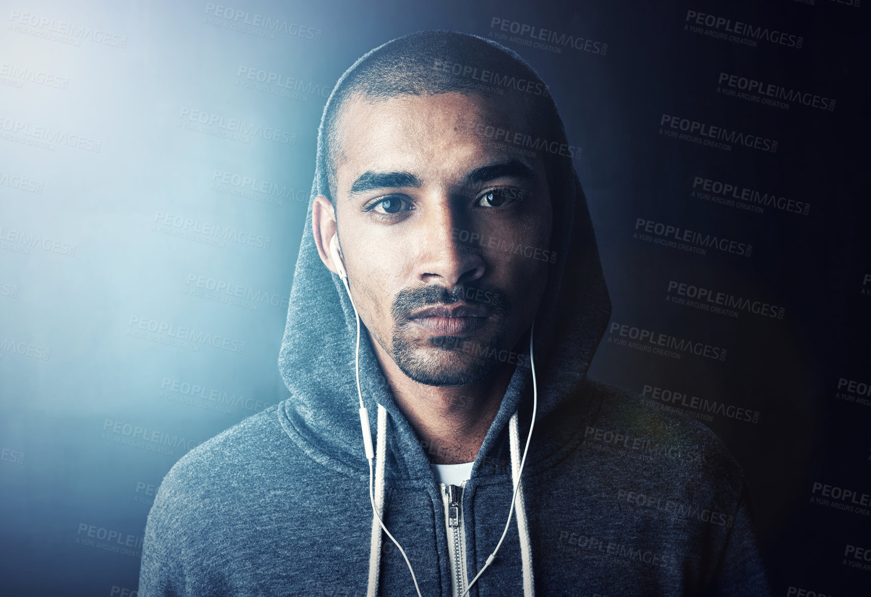 Buy stock photo Fitness, portrait and confident man in studio with earphones, hoodie and pride at gym workout. Health, wellness and athlete on music app for exercise, inspiration and commitment on dark background