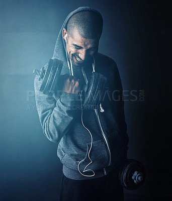 Buy stock photo Studio shot of a young man working out against a dark background