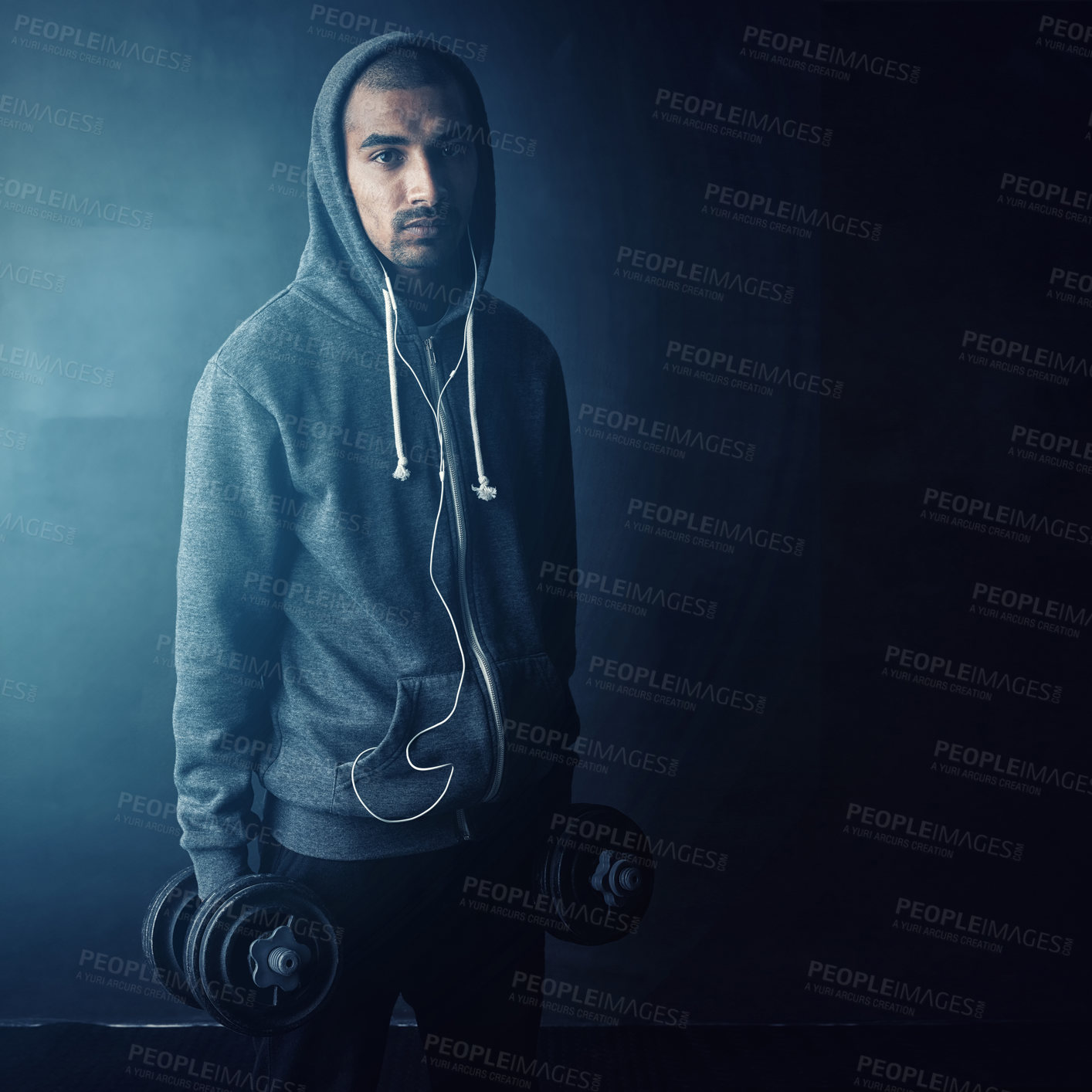 Buy stock photo Man, dumbbells and earphones in studio portrait, muscle and mock up space by dark background. Person, bodybuilder and happy with streaming subscription for training, workout and exercise in Mexico