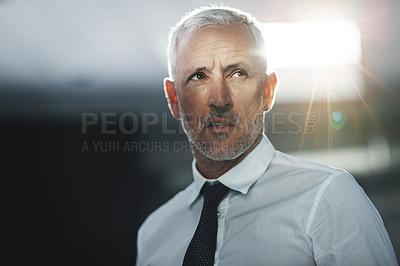 Buy stock photo Shot of a focused businessman standing in an office