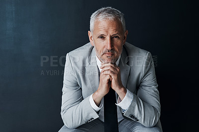 Buy stock photo Serious portrait of senior attorney sitting with confidence, mockup space and dark background in studio. Pride, professional career ceo and executive lawyer man, mature businessman or law firm boss.