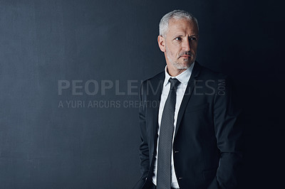 Buy stock photo Studio shot of a mature businessman against a dark background