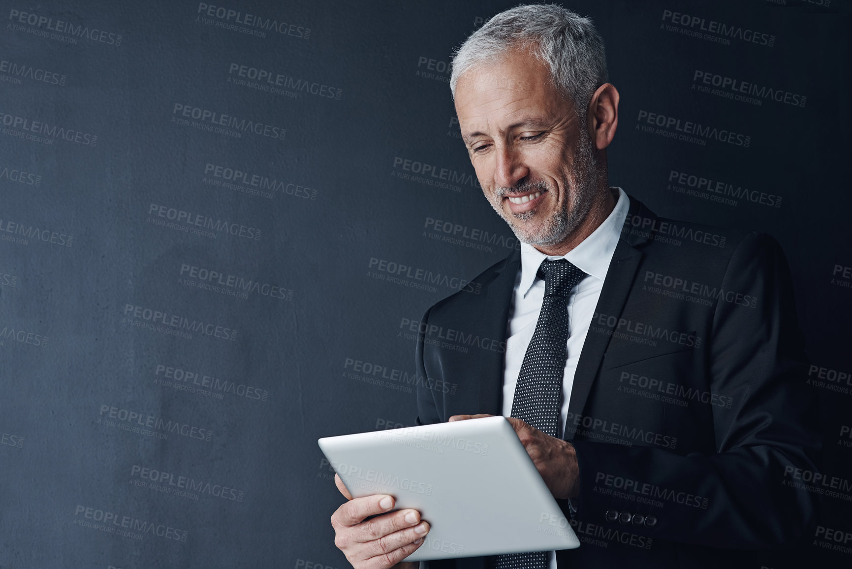 Buy stock photo Businessman, smile and online with tablet in studio for internet, website and news on stock exchange. Mature person, mockup space and happy for economy, market share and trading on black background