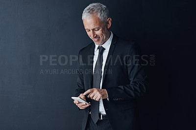 Buy stock photo Business, ceo and mature man with a smartphone, connection and contact on a dark studio background. Male person, employee and consultant with a cellphone, mobile app and network with online reading