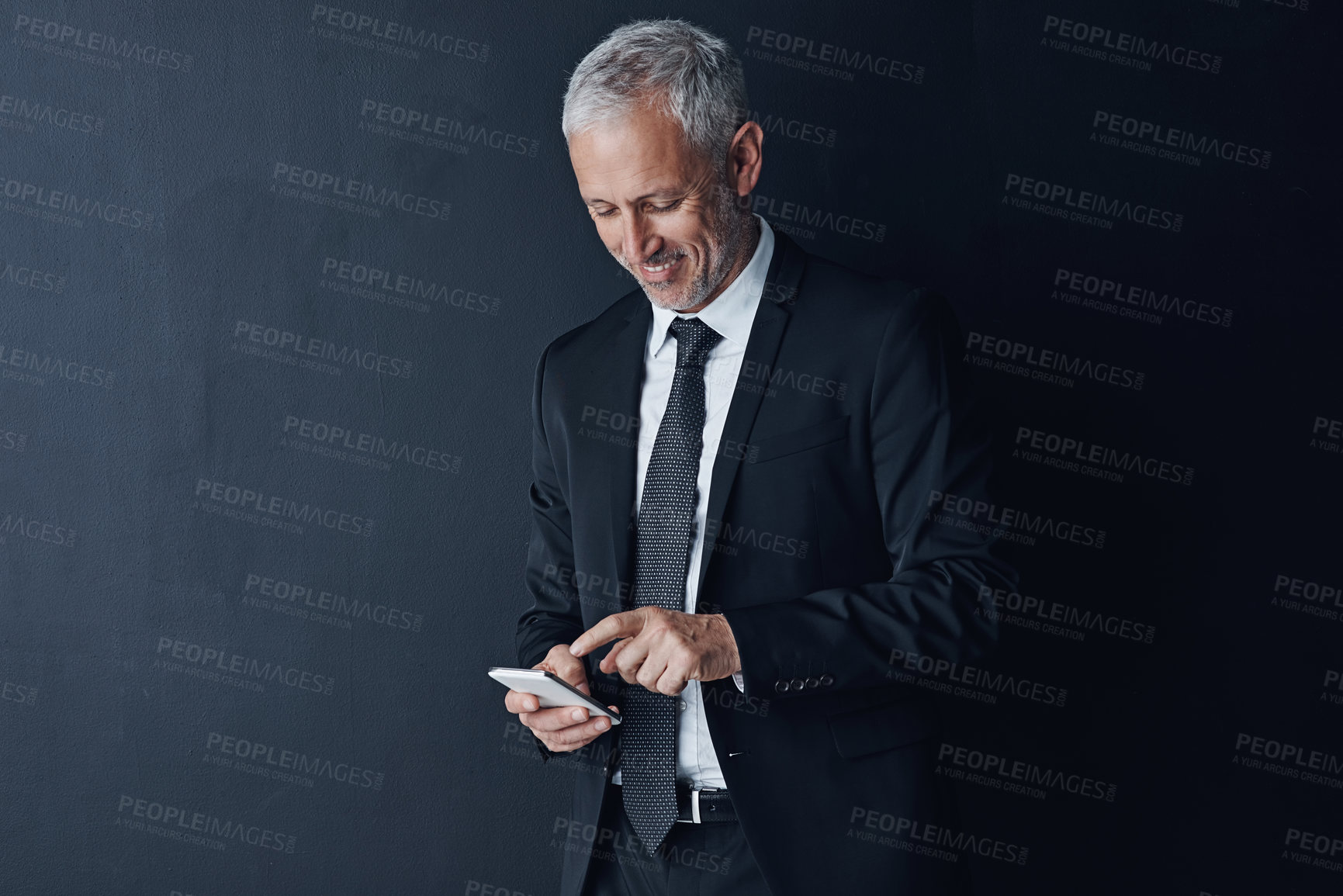 Buy stock photo Business, ceo and mature man with a smartphone, connection and contact on a dark studio background. Male person, employee and consultant with a cellphone, mobile app and network with online reading