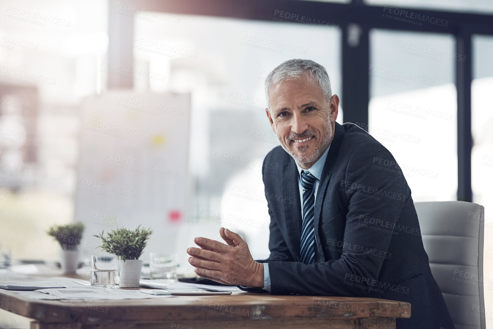 Buy stock photo Portrait of a mature businessman sitting at his desk in the office