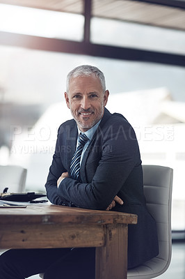 Buy stock photo Portrait of a mature businessman sitting at his desk in the office