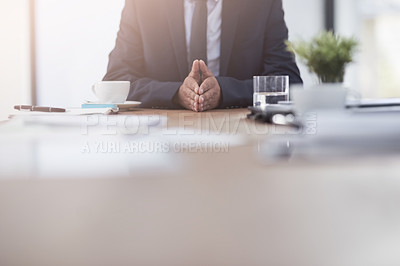 Buy stock photo Cropped shot of a businessmen working at his desk in a modern office