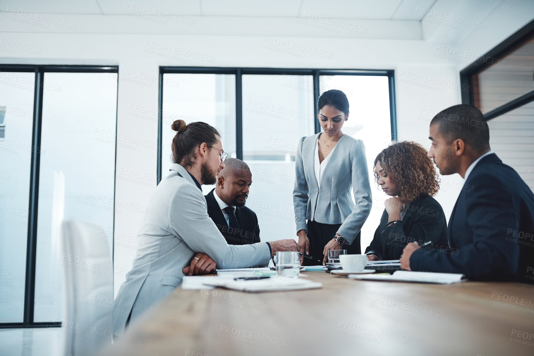 Buy stock photo Shot of a group of businesspeople having a discussion in a boardroom