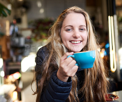 Buy stock photo Portrait of an attractive young woman enjoying a cappuccino in a coffee shop