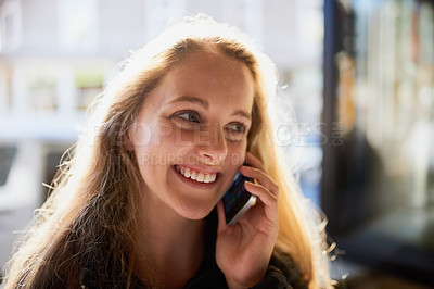 Buy stock photo Cropped shot of an attractive young woman talking on a cellphone
