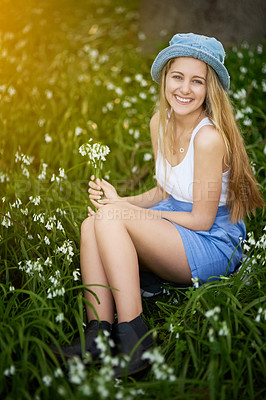 Buy stock photo Girl, portrait and style in field of flowers, travel and spring or grass for casual fashion in garden. Female person, relax and countryside holiday or vacation, aesthetic and clothes in nature meadow