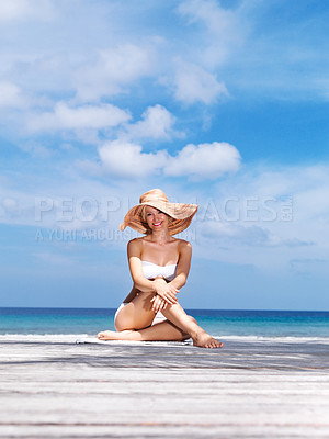Buy stock photo Portrait of sexy young woman in white bikini and hat posing by the sea