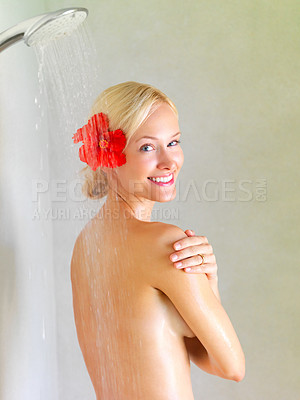 Buy stock photo Portrait of sexy young woman with a flower in her hair enjoying a shower