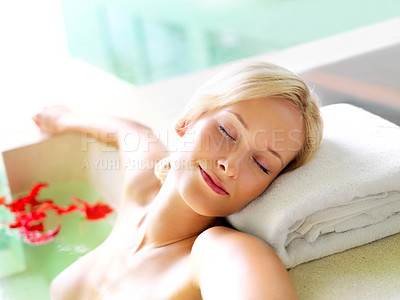 Buy stock photo Happy woman, spa and treatment by lying in bath for wellness, health and relaxing with care for body. Female person, eyes closed and enjoying for luxury, expensive and soak with petal for skincare