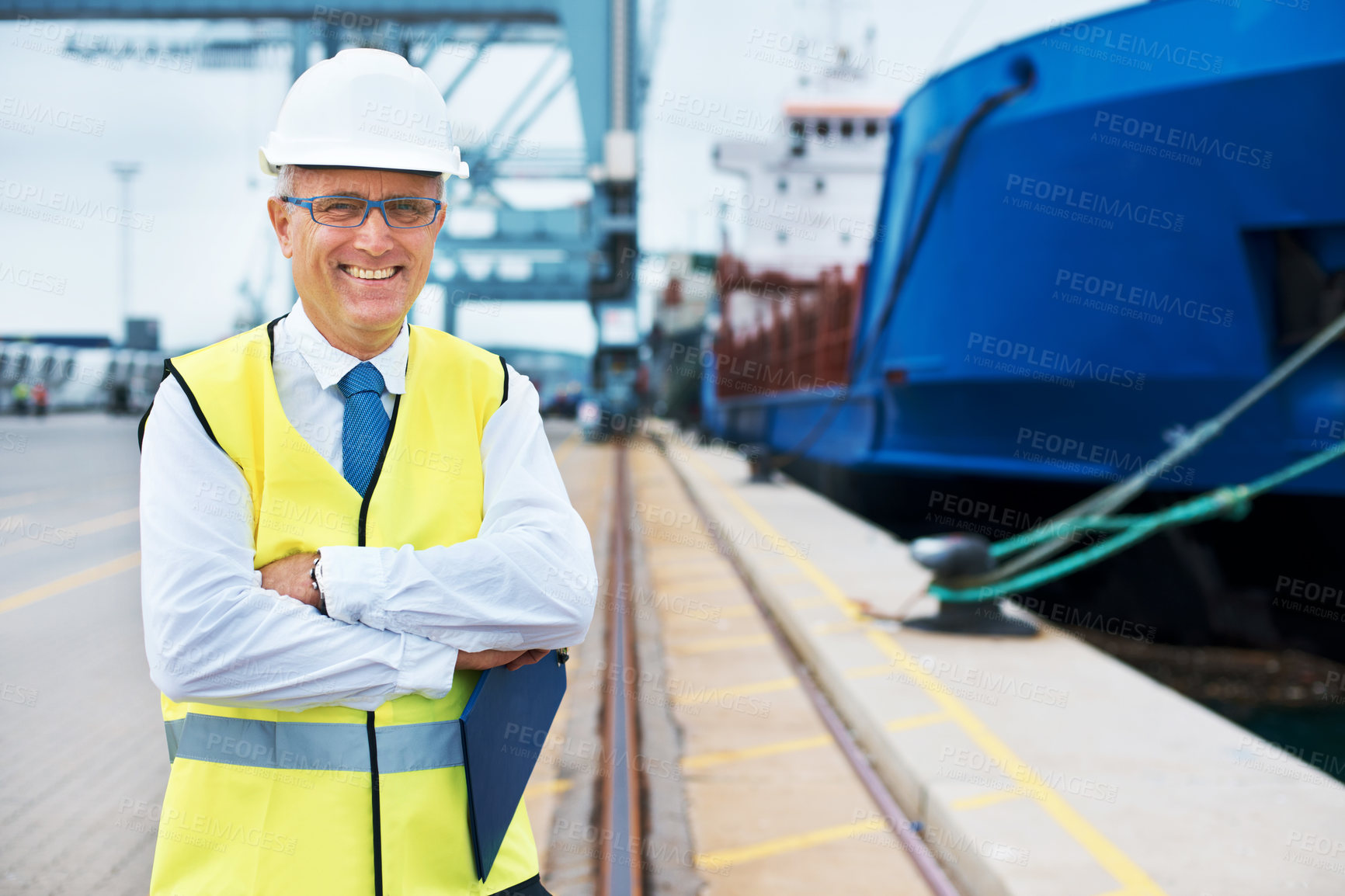 Buy stock photo Industrial worker working on a shipping port to export stock, containers and packages. Portrait of logistics, business and industry employee with a crane at a cargo freight warehouse dock.