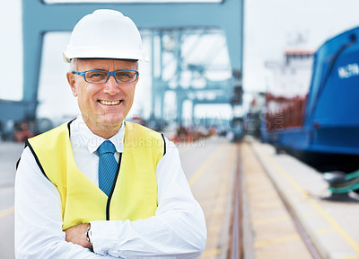 Buy stock photo Portrait of a dock worker standing at the harbor amidst shipping industry activity