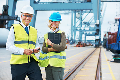 Buy stock photo A portrait of two dock workers standing together and smiling while on the job