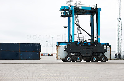 Buy stock photo Shipping, cargo and logistics with straddle carrier for container, delivery and transportation at port. Freight, export and global stock with loading vehicle for economy, storage and industrial 