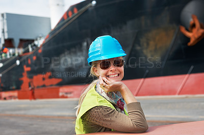 Buy stock photo A confident young woman resting her chin on her hands next to a ship.