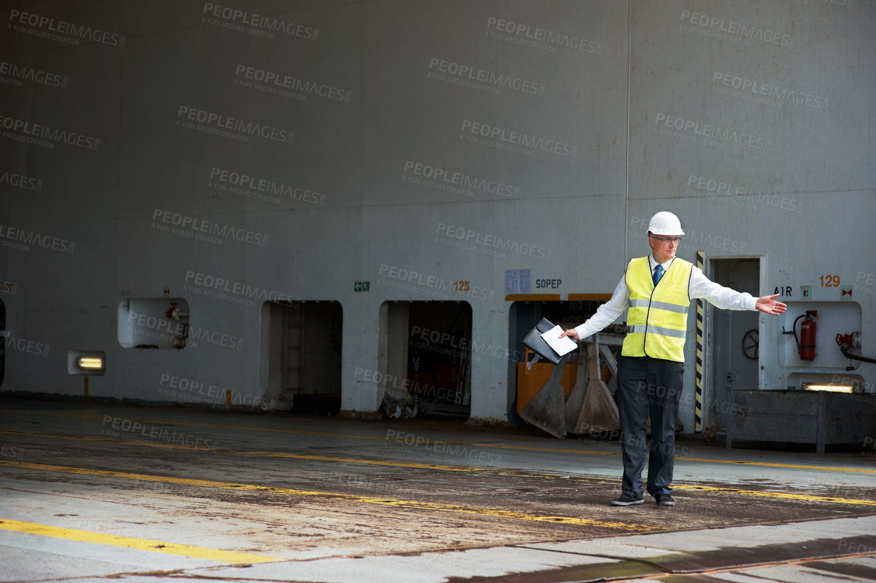 Buy stock photo Logistics worker, manager or engineer, working in a shipping yard or cargo dock. Port employee, giving direction to load container for safety, storage or export. Industrial management and planning.
