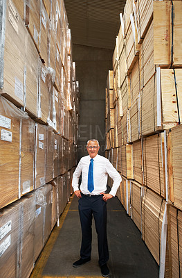 Buy stock photo Supply chain, industry and management with leader looking proud in a warehouse, stock and product control. Mature manager checking supply, doing inventory in manufacturing factory with package orders