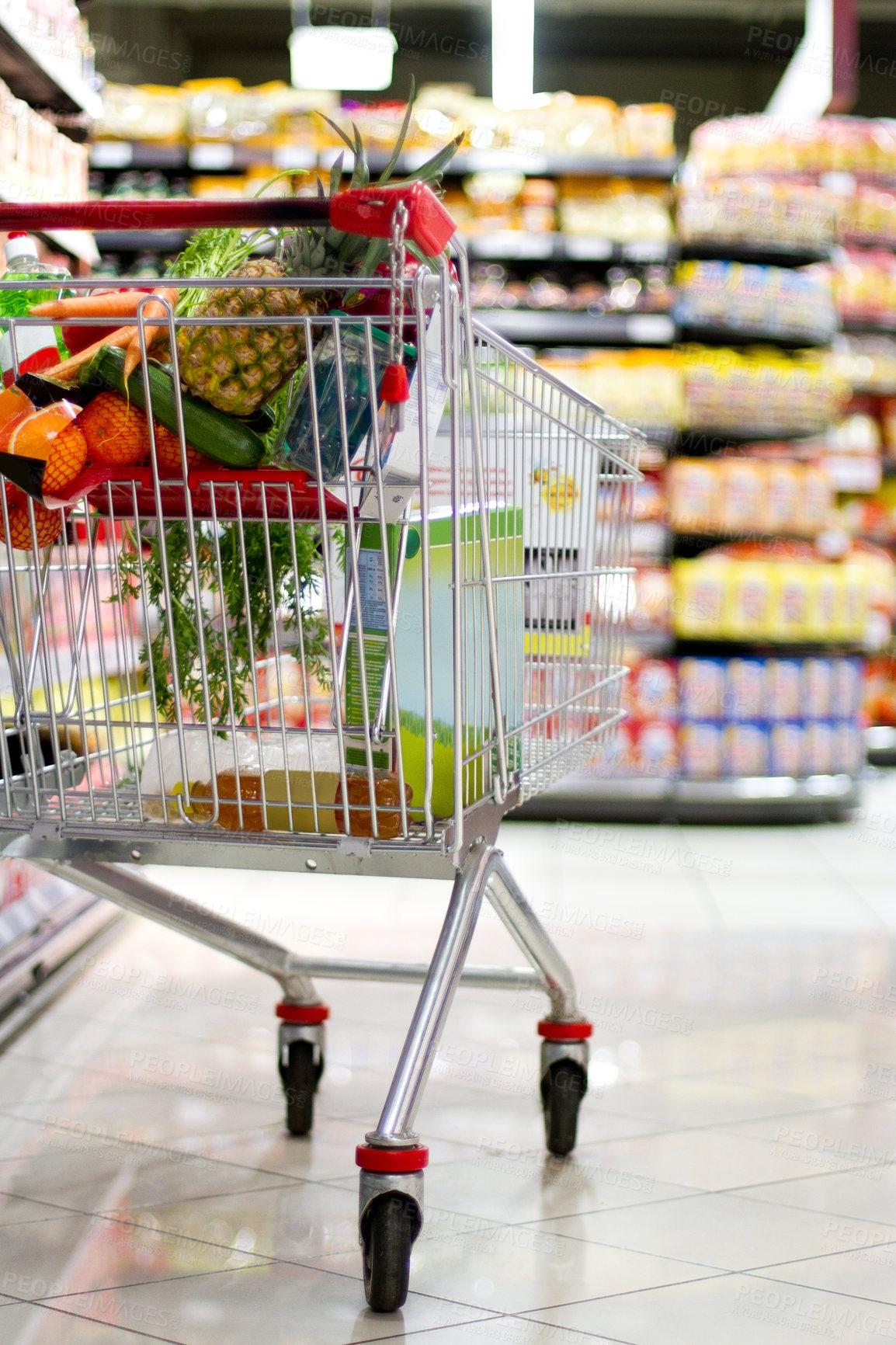 Buy stock photo A shopping cart filled with fresh groceries