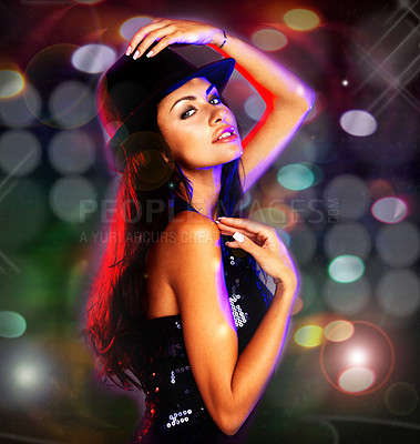 Buy stock photo Shot of a sexy young woman posing in an evening dress and hat