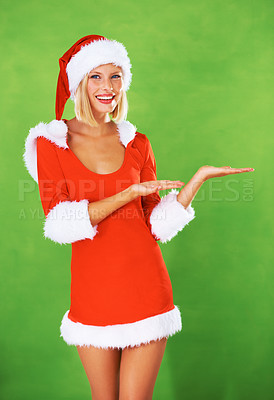 Buy stock photo Woman, Christmas and palm in studio with smile for festive holiday, celebration or gift event. Female person, santa hat and face on green background mockup for promotion, giveaway or present sales
