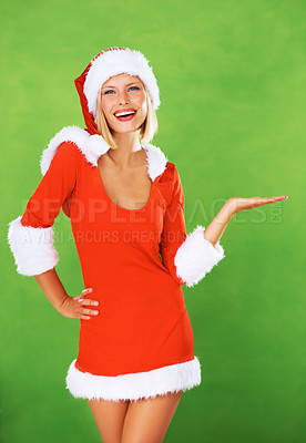 Buy stock photo Woman, Christmas and palm as portrait in studio for festive holiday, celebration or advertising. Female person, santa hat and face on green background mockup for promotion, giveaway or present sales