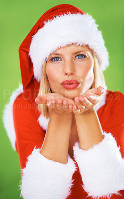 Buy stock photo Woman, Christmas holiday and kiss as portrait for festive celebration, season greeting or winter vacation. Female person, hand gesture and red hat for giving love, green background or happy hello
