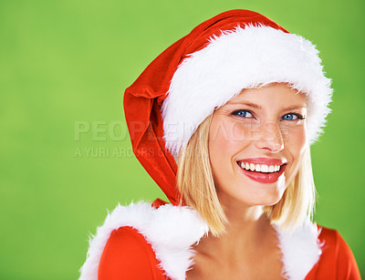 Buy stock photo Cute portrait of a happy young female modeling a red Father Christmas hat with white fur trim, isolated on green - copyspace