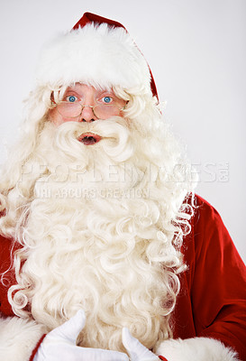 Buy stock photo Santa claus, surprise and portrait in studio for Christmas celebration, season greeting or vacation joy. Male person, shock emoji face and red costume for holiday traditions, event or wow fun mockup