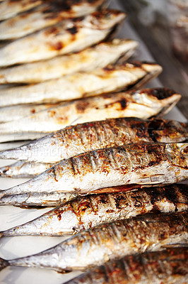 Buy stock photo Closeup of cooked sardines in row ready for eating at a Thai market stall