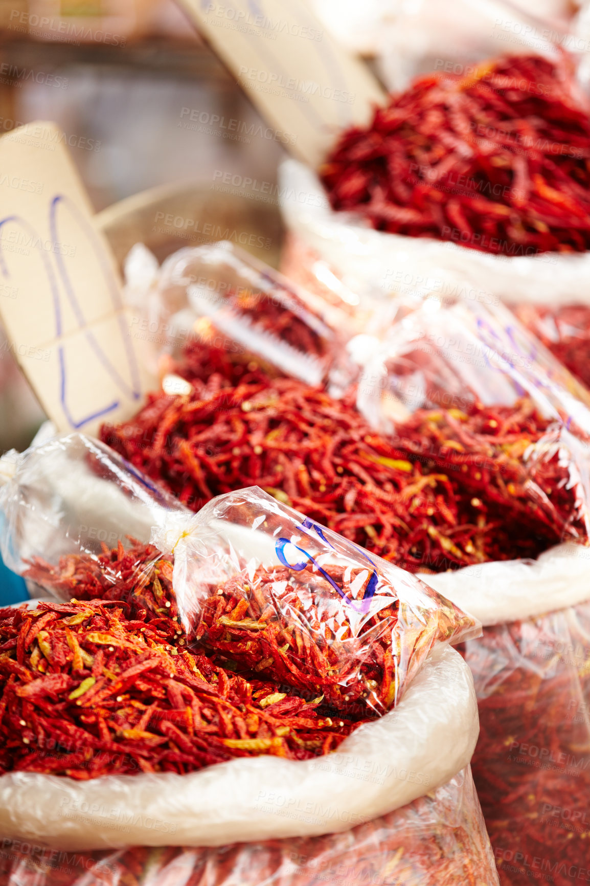 Buy stock photo Chilli, pepper and market for shopping sale, discount or wholesale promotion at vendor store or local trading. Bag of dried fruits, red vegetables and spice for food and flavor with empty background