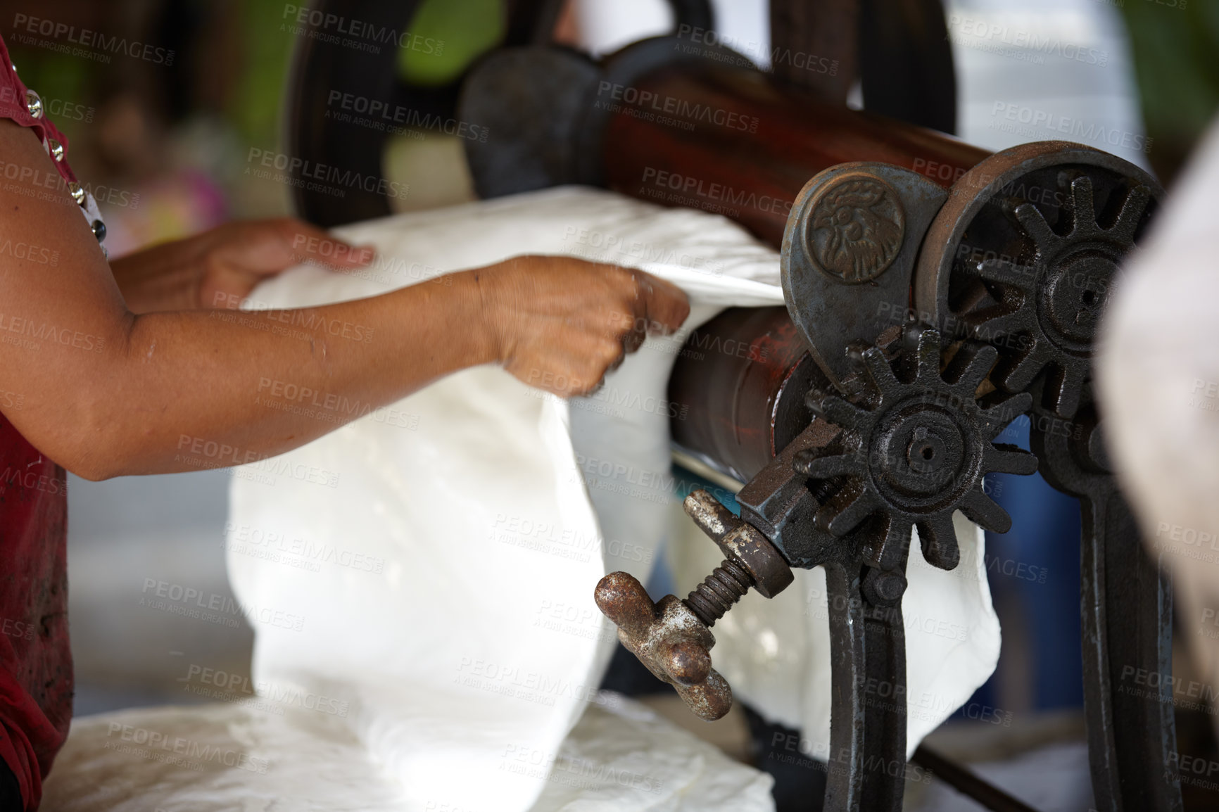 Buy stock photo Plastic, industry and hands of person with roller in workshop, factory and outdoor warehouse. Manufacturing, production and worker with machine for rolling latex, rubber and material plantation