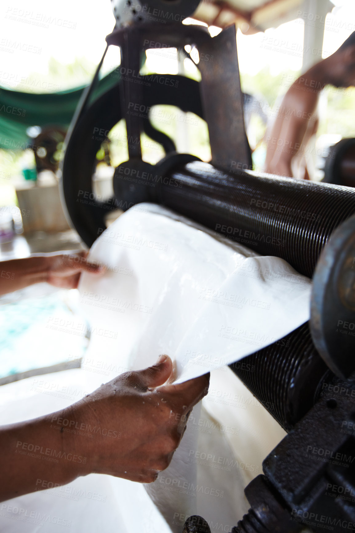 Buy stock photo Rubber, industry and hands of person with roller in workshop, factory and outdoor warehouse. Manufacturing, production and person with machine for rolling latex, plastic and material plantation