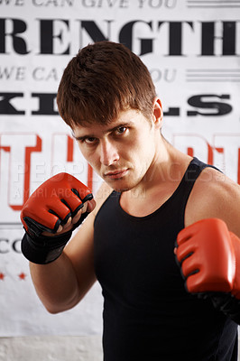 Buy stock photo Man, portrait and professional fighter with boxing gloves in martial arts or MMA sports for self defense in dojo. Serious male person, athlete or boxer ready for fight, match or muay thai at the gym