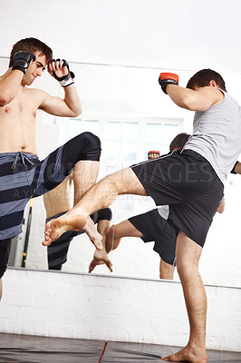 Buy stock photo Martial arts, kickboxing and men fight in gym, training and fitness with power, strong and MMA for sport. Exercise, workout and athlete in dojo, competition or contest with boxer, action and muscle