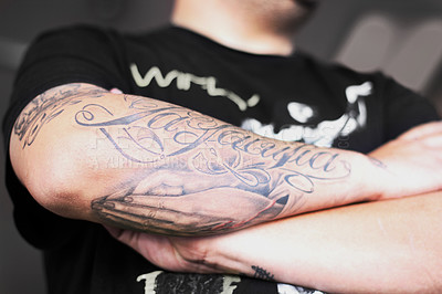 Buy stock photo Closeup shot of a man crossing his tattooed arms